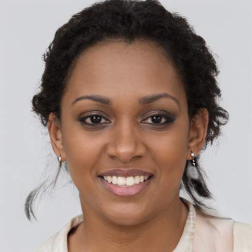 Joyful black young-adult female with medium  brown hair and brown eyes