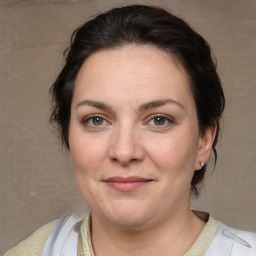 Joyful white adult female with medium  brown hair and brown eyes