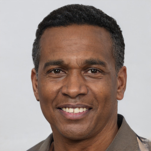 Joyful latino adult male with short  black hair and brown eyes
