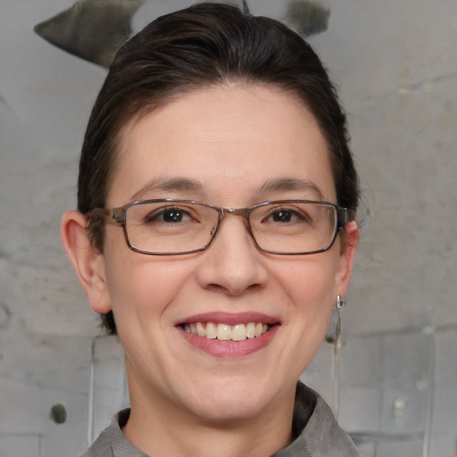 Joyful white adult female with medium  brown hair and grey eyes