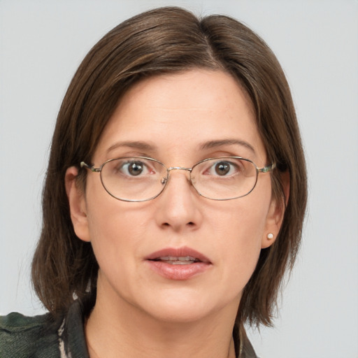 Joyful white adult female with medium  brown hair and grey eyes