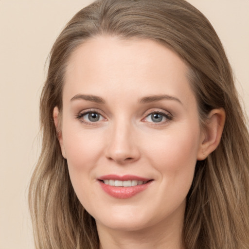 Joyful white young-adult female with long  brown hair and grey eyes