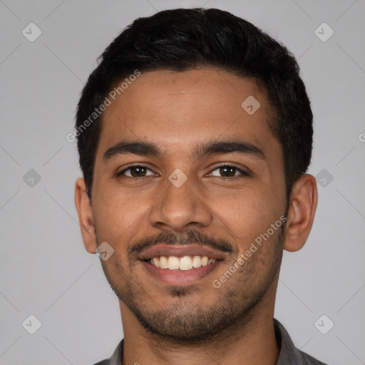 Joyful latino young-adult male with short  brown hair and brown eyes