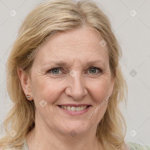 Joyful white adult female with medium  brown hair and blue eyes