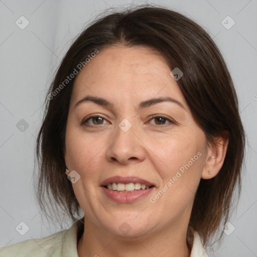 Joyful white adult female with medium  brown hair and brown eyes