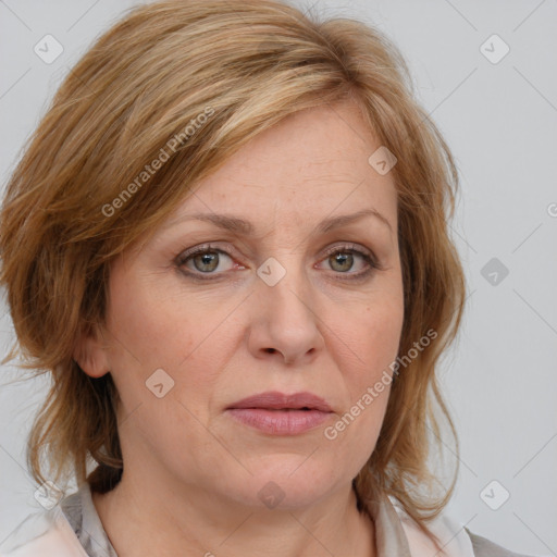 Joyful white adult female with medium  brown hair and blue eyes