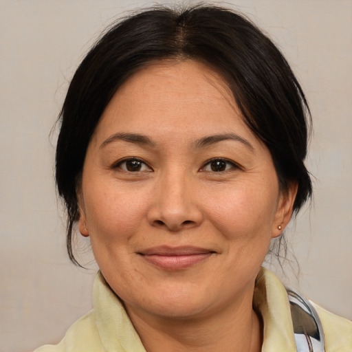 Joyful white adult female with medium  brown hair and brown eyes