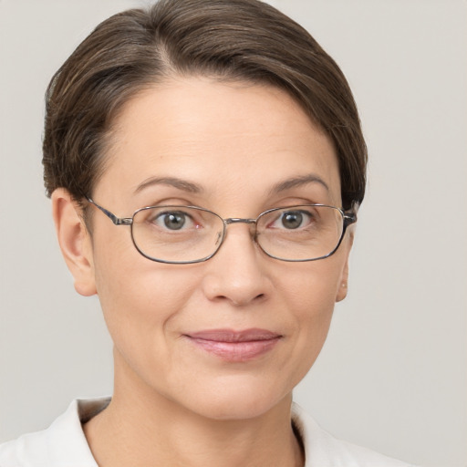 Joyful white adult female with short  brown hair and brown eyes