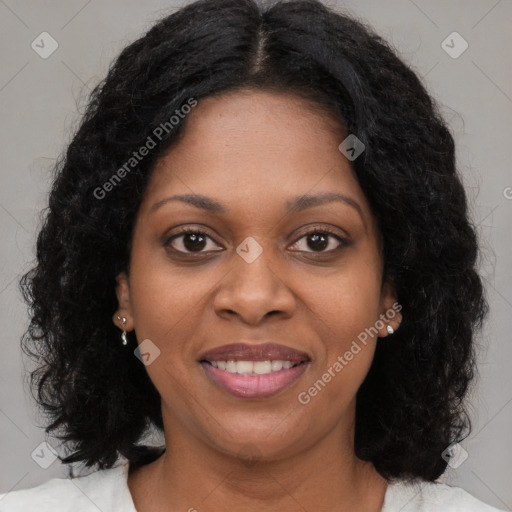 Joyful black young-adult female with long  brown hair and brown eyes