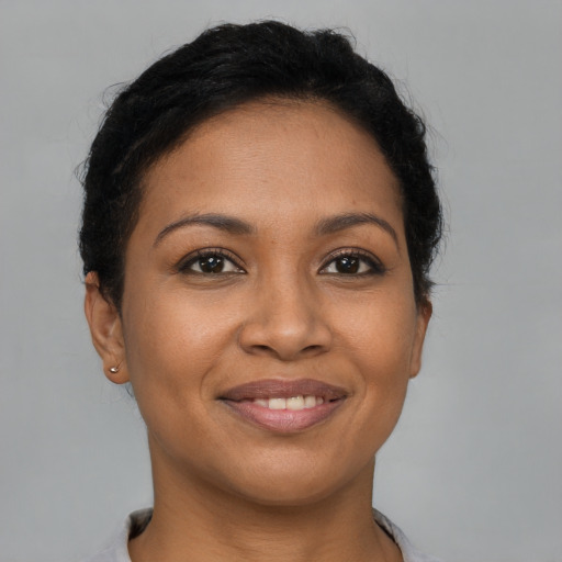 Joyful black young-adult female with short  brown hair and brown eyes