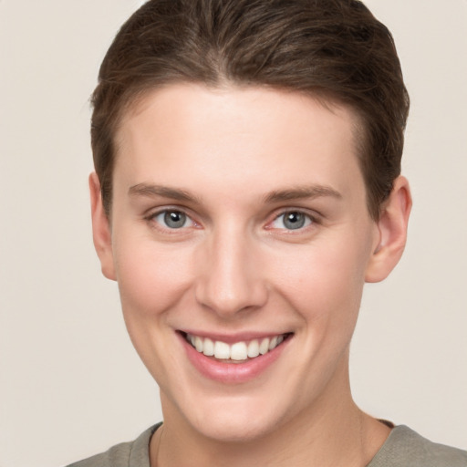 Joyful white young-adult female with short  brown hair and grey eyes