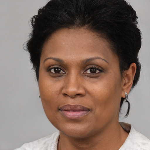 Joyful black adult female with short  brown hair and brown eyes