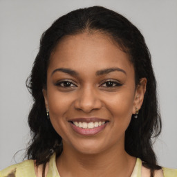 Joyful latino young-adult female with long  brown hair and brown eyes