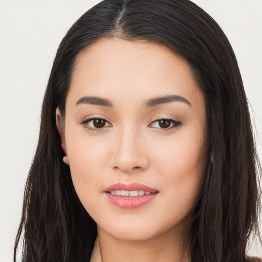 Joyful asian young-adult female with long  brown hair and brown eyes