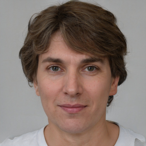 Joyful white adult male with medium  brown hair and brown eyes