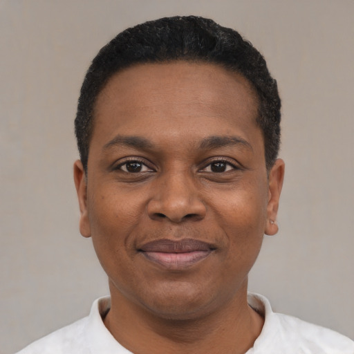 Joyful black young-adult male with short  black hair and brown eyes