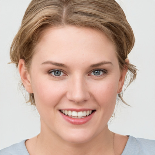 Joyful white young-adult female with medium  brown hair and blue eyes