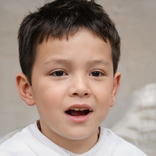 Joyful white child male with short  brown hair and brown eyes