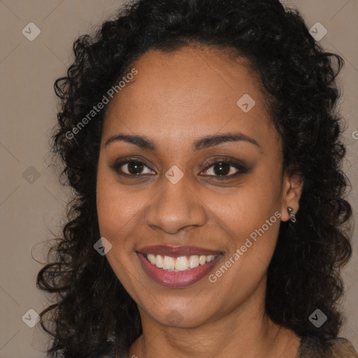 Joyful black young-adult female with long  brown hair and brown eyes