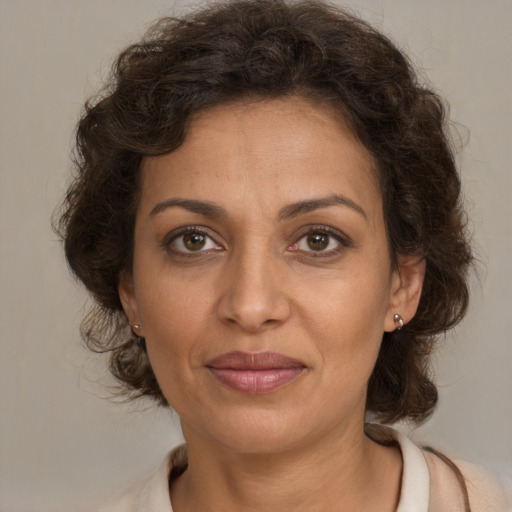 Joyful white adult female with medium  brown hair and brown eyes