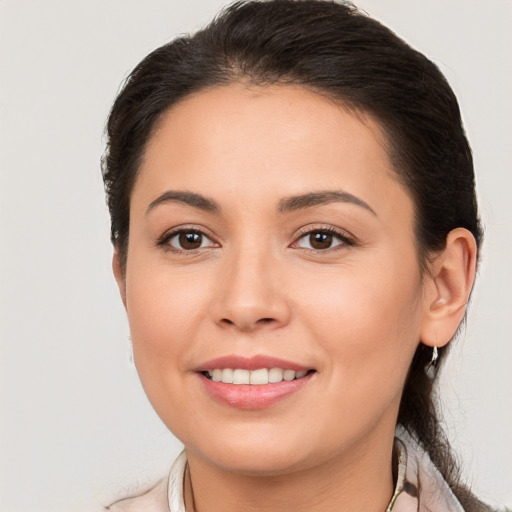 Joyful white young-adult female with long  brown hair and brown eyes