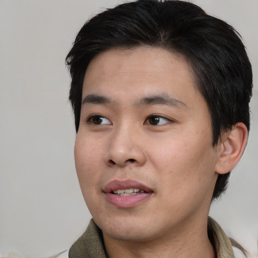 Joyful asian young-adult male with short  black hair and brown eyes