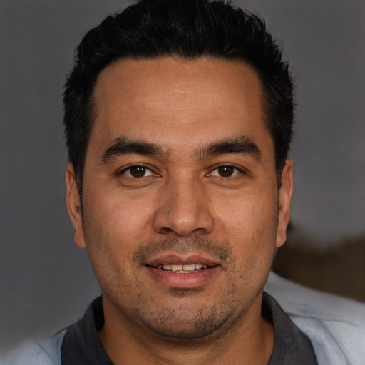 Joyful white young-adult male with short  black hair and brown eyes