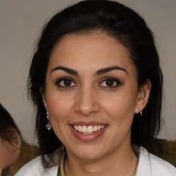 Joyful latino young-adult female with medium  brown hair and brown eyes