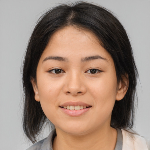 Joyful asian young-adult female with medium  brown hair and brown eyes