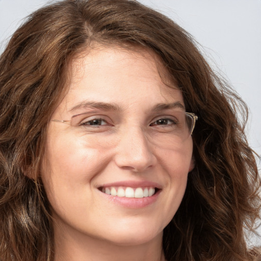 Joyful white young-adult female with long  brown hair and green eyes