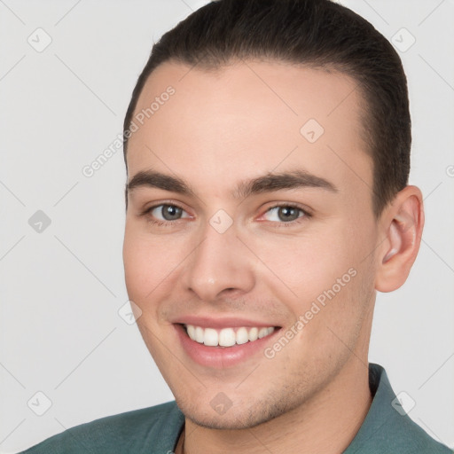 Joyful white young-adult male with short  brown hair and brown eyes