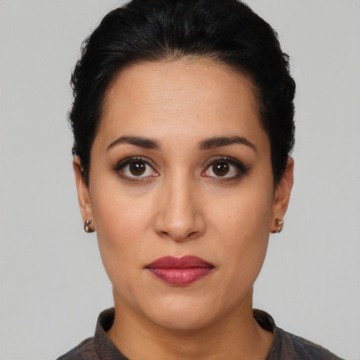 Joyful latino young-adult female with short  brown hair and brown eyes