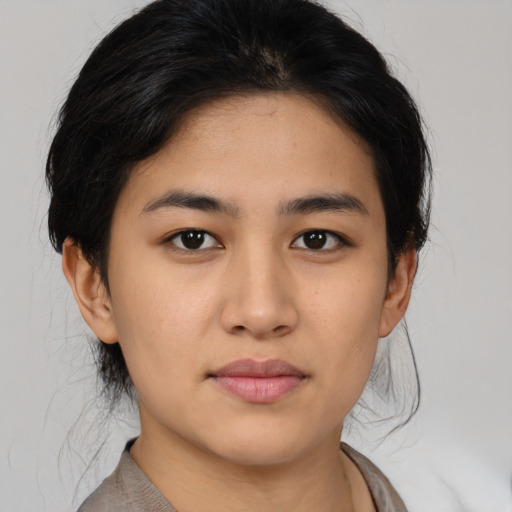 Joyful asian young-adult female with medium  black hair and brown eyes