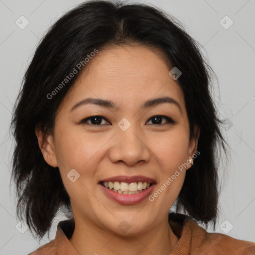 Joyful asian adult female with medium  brown hair and brown eyes