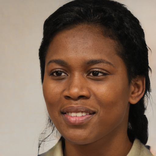 Joyful black young-adult female with medium  black hair and brown eyes