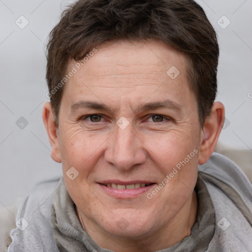 Joyful white adult male with short  brown hair and brown eyes