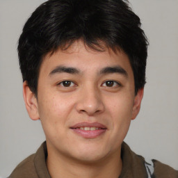 Joyful asian young-adult male with short  brown hair and brown eyes