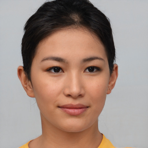 Joyful asian young-adult female with short  brown hair and brown eyes