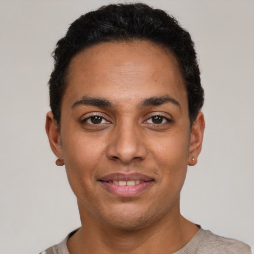 Joyful latino adult male with short  black hair and brown eyes