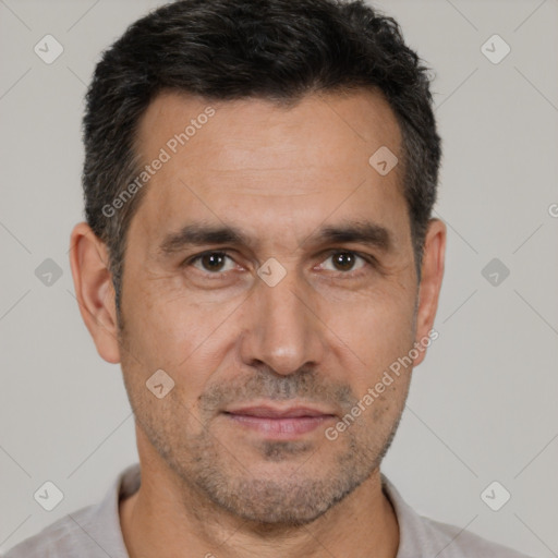 Joyful white adult male with short  brown hair and brown eyes