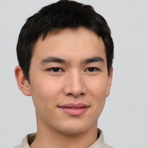 Joyful asian young-adult male with short  brown hair and brown eyes