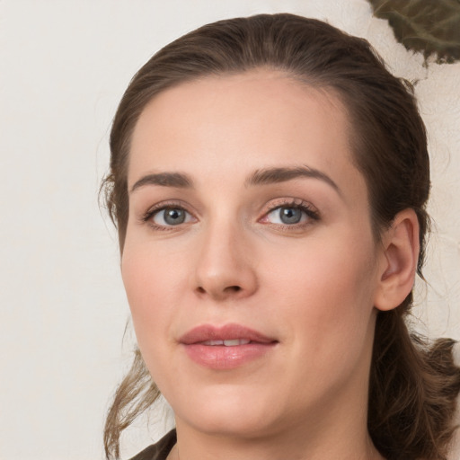 Joyful white young-adult female with medium  brown hair and green eyes