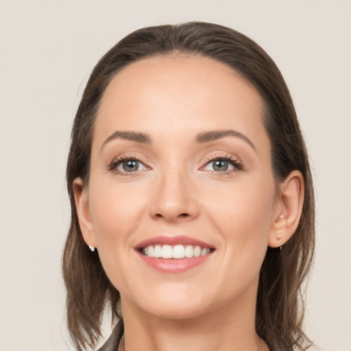 Joyful white young-adult female with medium  brown hair and brown eyes