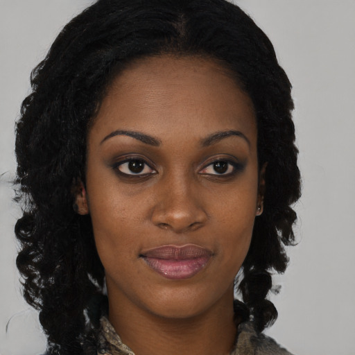 Joyful black young-adult female with long  brown hair and brown eyes