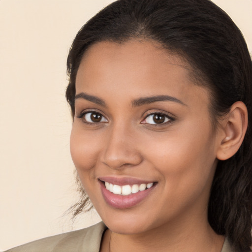 Joyful white young-adult female with long  brown hair and brown eyes