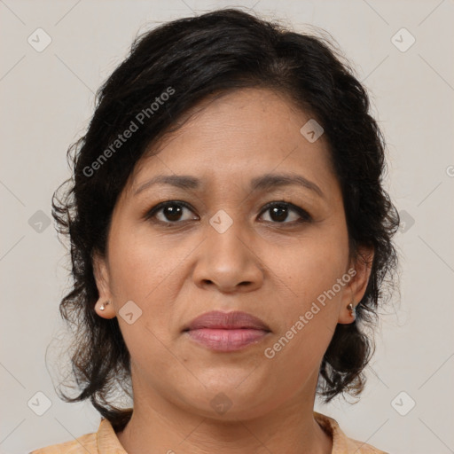 Joyful latino adult female with medium  brown hair and brown eyes