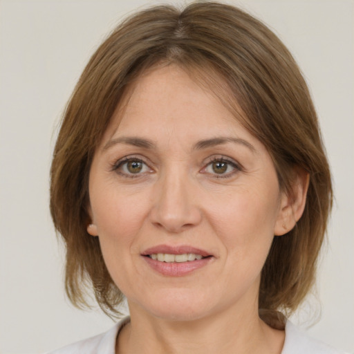 Joyful white adult female with medium  brown hair and brown eyes