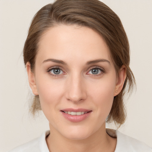 Joyful white young-adult female with medium  brown hair and grey eyes