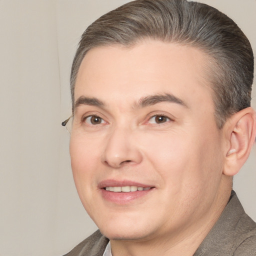 Joyful white adult male with short  brown hair and brown eyes