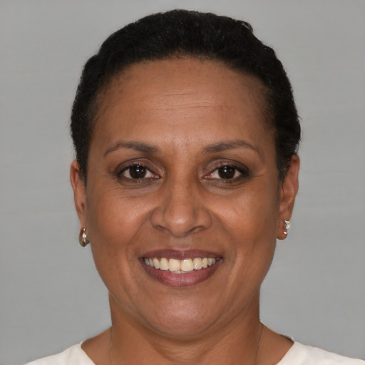 Joyful black adult female with short  brown hair and brown eyes
